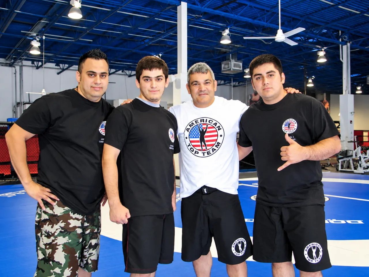 The Galvan brothers with Ricardo Liborio at American Top Team in Miami, Florida, holding their MMA instructor certificates