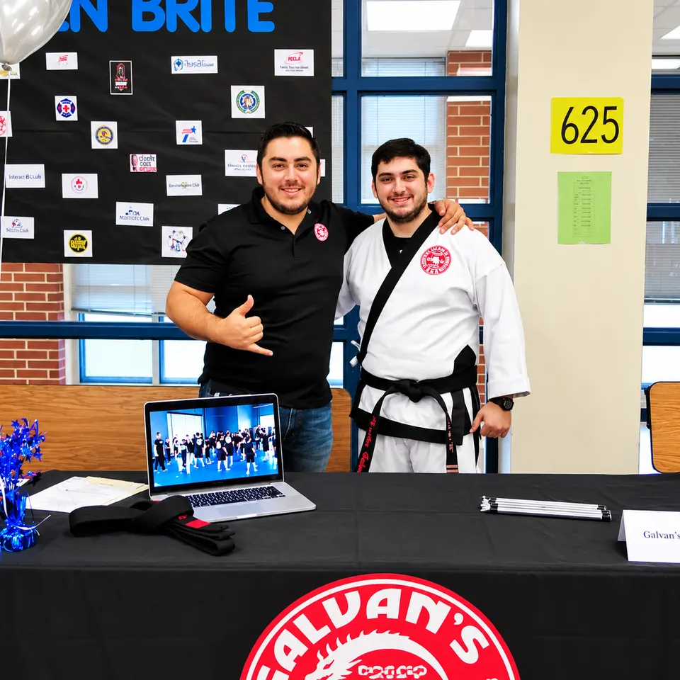 Manny Galvan and a Galvan’s Martial Arts instructor at their school talk table